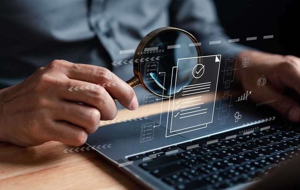 Government officials reviewing digital contract management software on laptop screen