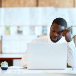 Frustrated event organizer reviewing incomplete paper sign in sheet with illegible handwriting and missing attendee contact information