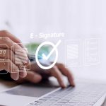 Legal professional reviewing binding contract elements on digital tablet with electronic signature authentication