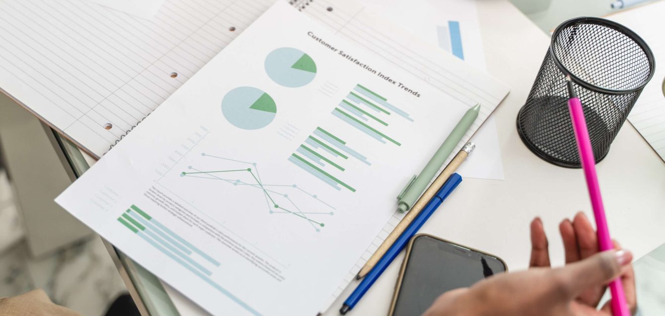 Business professional analyzing real-time market research survey data on tablet showing mobile completion trends and consumer insights dashboard.